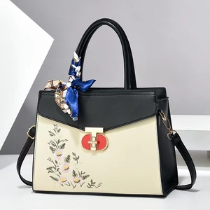 Contrast color handbag with floral embroidery and silk scarf handle on shoulder bag