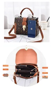 Detail showing internal compartments of the vintage brown crossbody bag with dual main pockets