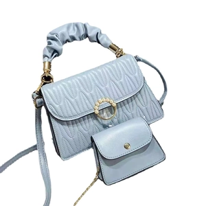 Light blue quilted satchel with pearl buckle, braided handle and matching coin purse