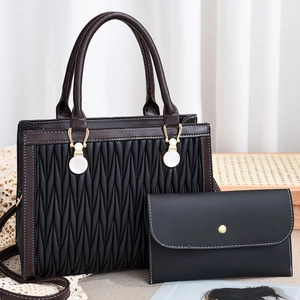 Quilted embroidery handbag set with gold circular handle and matching envelope clutch