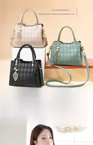 Detailed view of rhombic textured handbags with metal leaf and pearl pendant decor