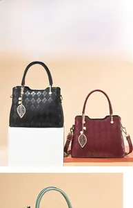 Detail of diamond quilted texture on black and burgundy tote bags with pearl charm
