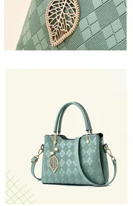Macro view of mint green rhombus quilted faux leather and gold leaf pendant with pearls