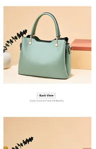 Rear view of mint green tote bag showing pearl-studded handles and gold-tone hardware