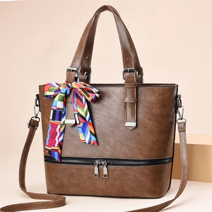 Brown vintage faux leather tote bag with decorative scarf and silver zipper details