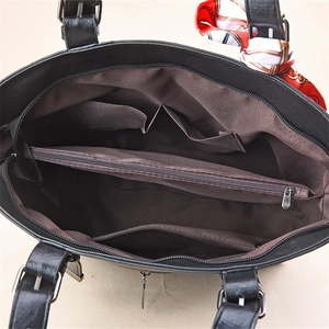 Interior view of black leather tote bag with large zipper compartment and silk scarf detail