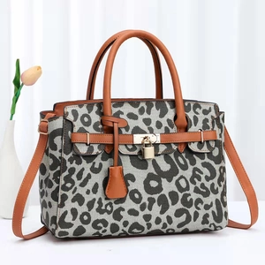 Women's 2024 cow print fashion handbag with leather handles and golden lock detail