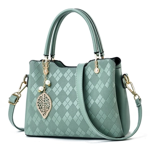 Green rhombic embossed tote bag with gold leaf pendant and adjustable shoulder strap