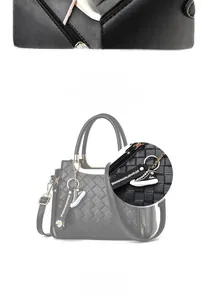 Detail of woven texture black tote bag with magnetic buckle and sneaker charm
