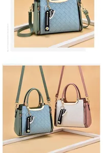Detail of woven texture PU leather bag with round metal handles and flower charm