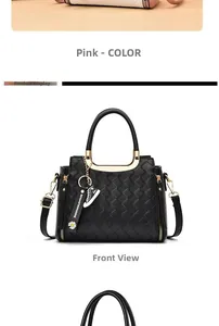 Detailed view of woven texture tote bag with gold metal handle and daisy charm