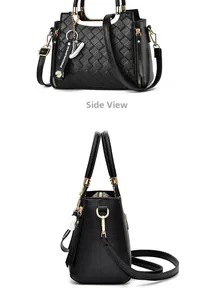 Detail view of black quilted PU leather handbag featuring dual handles and side zipper pocket