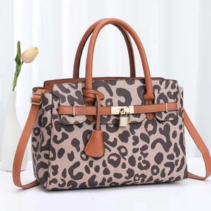 Fashionable leopard print handbag for women with brown handles and gold hardware detail
