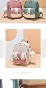 Detail of quilted backpack flaps with golden bee metal clasps and plush ball charms
