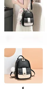 Detail showing contrast quilted pocket and fuzzy keychain on black and white backpack