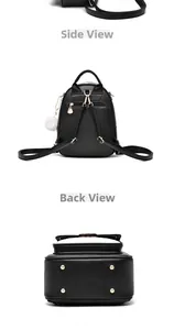 Detail of black PU leather backpack with gold zippers and white plush pompom charm