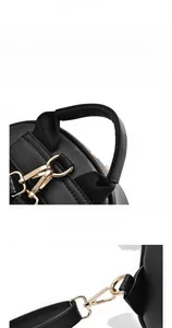Detail of the reinforced top handle and golden metal swivel hooks on the black backpack