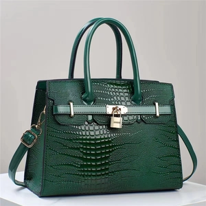 Deep green faux lizard pattern leather handbag with crossbody strap and metal padlock