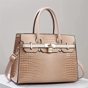 Beige faux lizard skin tote bag with gold lock closure and detachable shoulder strap
