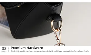 Macro shot of durable golden metal hardware and d-ring on black lychee leather handbag