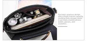 Interior view of black litchi pattern handbag with compartments and storage capacity