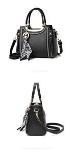 Detail of black tote bag with white contrast stitching and leopard print silk scarf