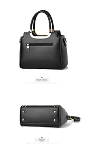 Detail view of black leather tote bag with gold back zipper and protective bottom studs