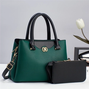 Dettaglio borsa tote in pelle martellata verde scuro con logo dorato e manici neri