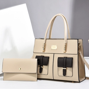 Beige tote bag with brown pockets and matching clutch set shown from a side angle view