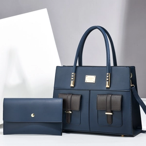 Dark blue leather tote bag and matching envelope clutch set with gold hardware accents