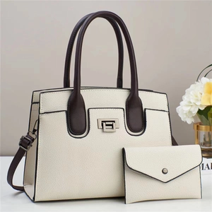 Detalle de set de bolsos en contraste con piel granulada y cierre de metal giratorio