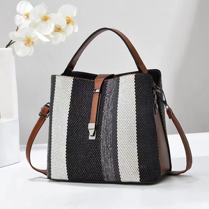Contrast striped bucket bag with brown leather trim and metallic buckle detail