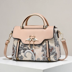 Vintage paisley print leather handbag with swan heart clasp and pearl tassel detail