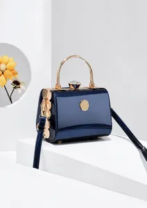 Detail of royal blue stone pattern evening bag with gold circular metal handle and jewelry clasp