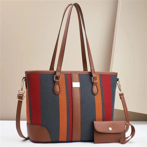 Detailed view of color-block fabric tote bag set with matching coin purse and leather strap