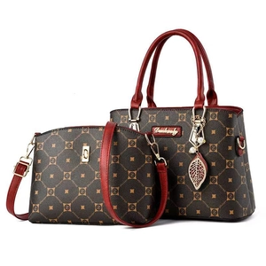Two-piece tote and crossbody bag set in brown logo print with vibrant red handles