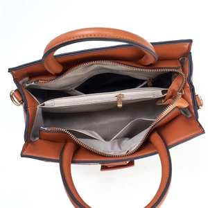 Interior view of leather tote bag showing large compartments and herringbone lining