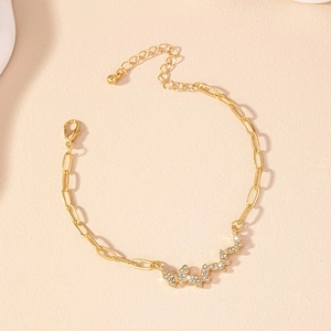 Detail of gold butterfly bracelet featuring sparkling pavé crystals and thick link chain