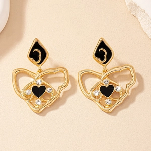 Boucles d'oreilles vintage en or avec cœur émaillé noir et accents de cristal
