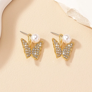 Boucles d'oreilles papillon dorées avec perles et cristaux présentées de dessus