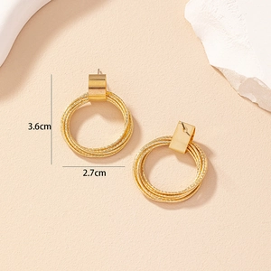 Detailed view of layered gold hoop earrings with dimensions measuring 3.6cm by 2.7cm