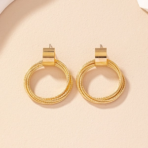 Minimalist geometric circle earrings in gold finish featuring overlapping round wire rings