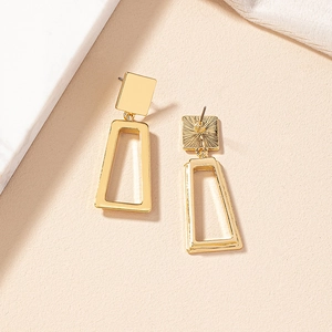 Detailed view of gold geometric trapezoid earrings with polished finish and secure studs