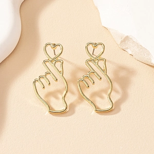 Minimalist gold heart earrings featuring unique finger heart gesture and hollow heart design