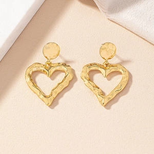 Exaggerated golden heart drop earrings with hammered metal texture for women