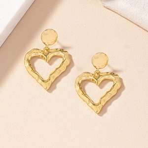 Vintage gold hollow heart earrings with hammered metal texture in 45-degree view