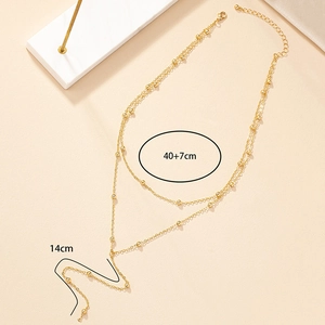 Detail view of gold beaded double-layer necklace with 40+7cm chain and 14cm tassel drop