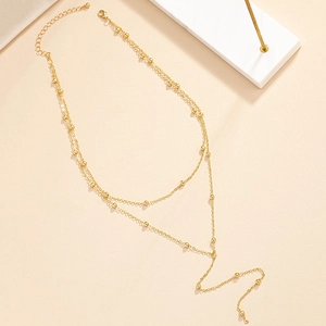 Close-up of golden double-layer beaded tassel necklace with elegant adjustable lobster clasp