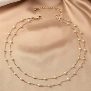 Elegant double-layered gold necklace with lustrous freshwater pearls and adjustable chain