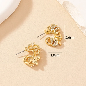 Macro detail of gold-hued geometric earrings with rhinestones measuring 2.6cm by 1.8cm